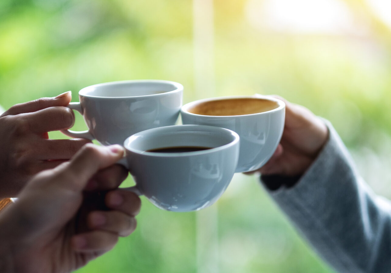 people holding cups made with Bruhub coffee services and toasting for a win or a celebration